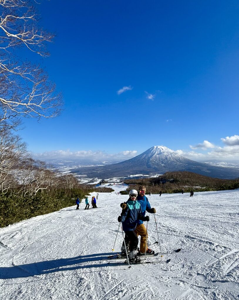 Kami and Zac skiing in Niseko, Hokkaido. Mount Yotei in the background.