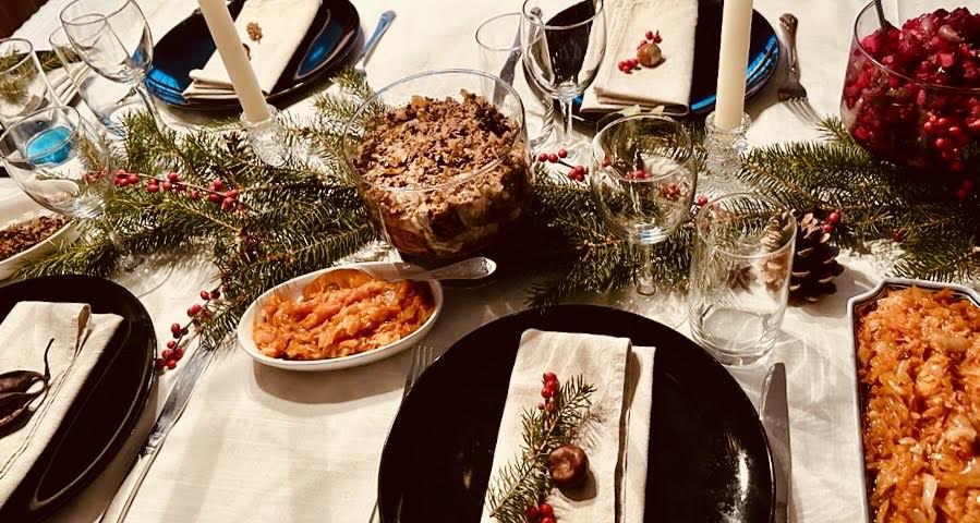 Table setting for Lithuanian Christmas Eve dinner. White tablecloth is crucial, this signifies rebirth. Table decorations are natural and recall nature.