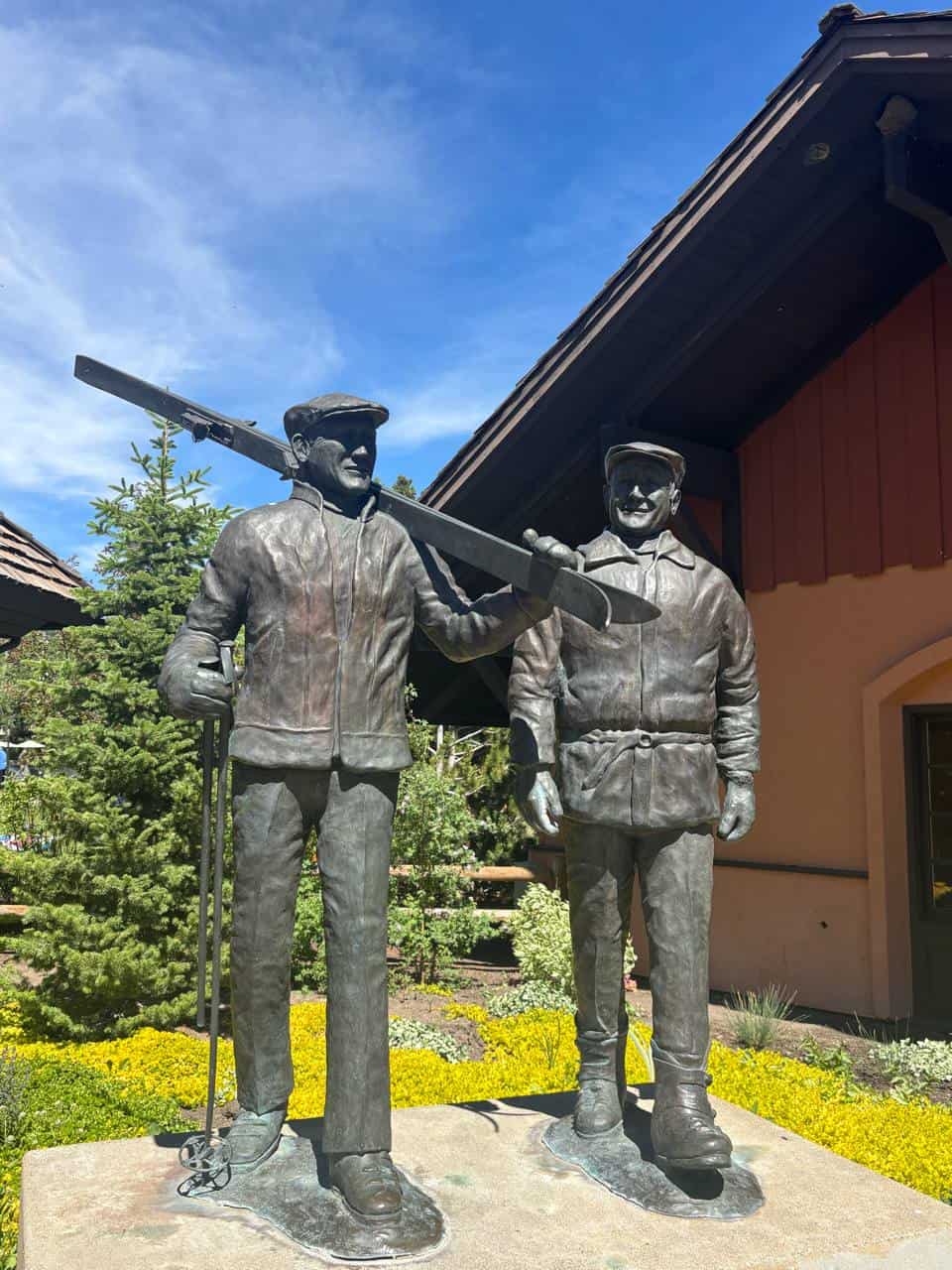 Bronze sculpture of Sun Valley founders with skis outside Sun Valley Village